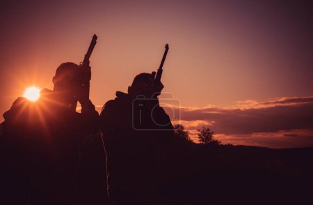 Photo for Silhouette of the hunter. Hunting Equipment for sale. Rifle Hunter Silhouetted in Beautiful Sunset. Copy space for text - Royalty Free Image