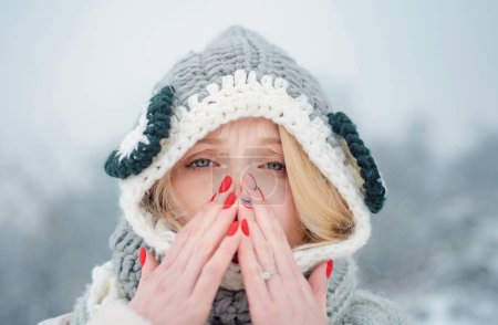 Foto de Mujer con síntomas de alergia invernal sonándose la nariz. Retrato de una mujer joven oliendo aerosol nasal cerrando una fosa nasal. Mujer sintiéndose enferma con la nariz corriendo usando medicamentos para los senos paranasales para la nariz bloqueada - Imagen libre de derechos