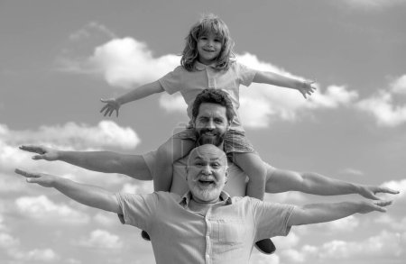 Photo for Fathers day. Family man different ages on weekend. Father and son with grandfather raising hands or open arms flying. Men generation - Royalty Free Image