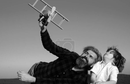 Photo for Father and son. Child pilot aviator with airplane dreams of traveling. Parent with child boy. Father playing with kid - Royalty Free Image