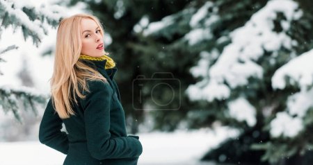 Photo for Winter woman in winter snowy background outdoor. Portrait of young beautiful woman wearing coat. Model walking in winter street - Royalty Free Image