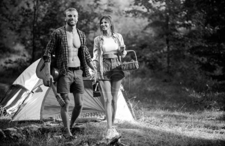 Foto de Romantic couple walking on camping, man with guitar. Outdoor adventure with friends on nature - Imagen libre de derechos