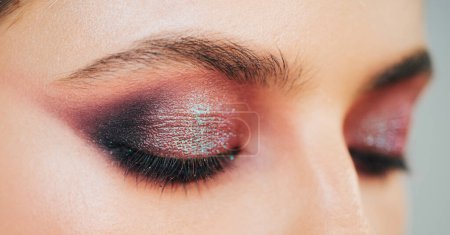 Photo for Close up womans eyes with shimmery purple smokey eyes makeup. Luxurious makeup by professional makeup artist in studio. Vogue, cosmetics and glamour concept - Royalty Free Image