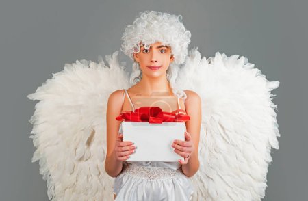 Photo for Angel with gift. Valentines cupid. Valentines Day: Gift, Romantic and Date. Romantic Gifts and Valentines Gift Ideas - Royalty Free Image
