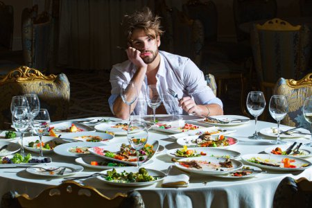 Photo for Taste food. Meals that cater to every taste. Delicious Food. Sexy Male Model with Foods. Overeating. Binge eating. Eating junk food. Funny man eating in the restaurant. Sexy man eat taste food - Royalty Free Image