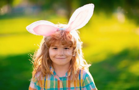 Photo for Bunny child. Child boy hunting easter eggs. Child boy with easter eggs and bunny ears in park - Royalty Free Image
