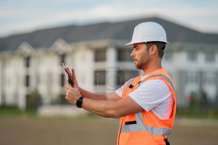 Photo for Portrait of builder in a construction site. Builder ready to build new house. Construction builder wear building uniform and helmet, builder on buildings construction background - Royalty Free Image