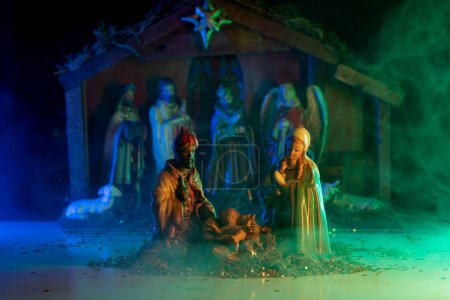 Téléchargez les photos : Scène de Noël traditionnelle naissance de Jésus. Manger de Noël scène avec des figures de Jésus, Marie, Joseph, moutons et mages. Statuettes de la Nativité - en image libre de droit