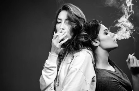 Photo for Addiction is a disease. Pretty women with smoking addiction. Sensual girls with nicitine addiction smoking cigarettes. Addiction and dependence, copy space. - Royalty Free Image