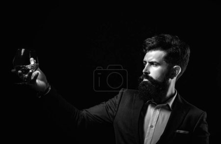 Photo for Treatment for alcohol problems. An elegant man suffering from alcoholism drinking whisky - Royalty Free Image