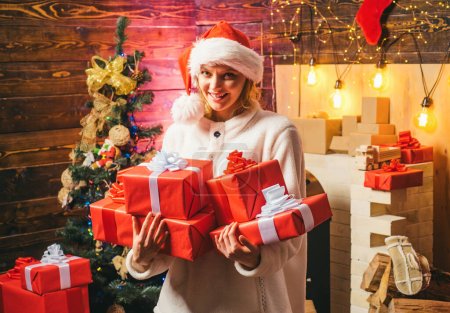 Photo for New years eve girl. Beautiful Woman with christmas box gif at Home. Christmas tree decorate at home. Holly jolly swag Christmas and noel. Comic grimace. Funny christmas girl - Royalty Free Image
