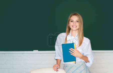 Photo for Portrait of smiling young college student studying in classroom. Learning and education concept - Royalty Free Image