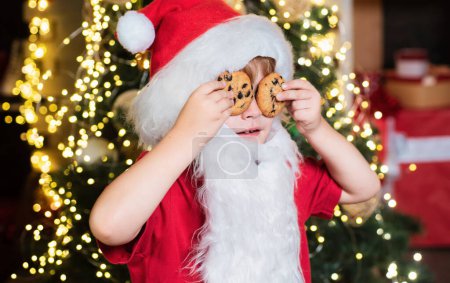 Téléchargez les photos : Portrait du Père Noël Boire du lait dans du verre et tenir des biscuits. Style barbe de Noël. Joyeux Noël. Père Noël en chapeau de Père Noël. Nourriture et boisson de Noël - en image libre de droit