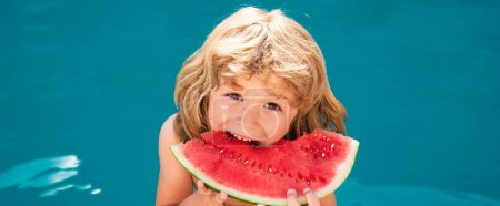 Foto de Funny amazed child eats watermelon near the pool. Banner for header, copy space. Poster for web design - Imagen libre de derechos
