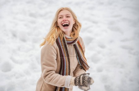 Photo for Cute playful young woman outdoor enjoying first snow. Portrait of a happy woman in the winter. Cheerful girl outdoors. Winter woman - Royalty Free Image