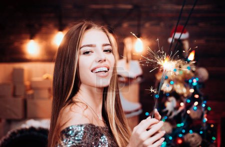 Photo for Celebration sparkles. Crazy comical face. Comic grimace. Positive human emotions facial expressions. Smiling woman decorating Christmas tree at home. Having fun - Royalty Free Image
