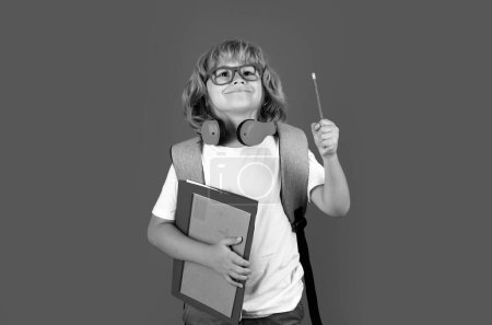 Photo for Learning knowledge and kids education concept. School teen boy in with backpack. Thinking pensive kids, thoughtful emotions of school child, clever smart funny nerd have idea - Royalty Free Image