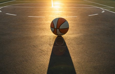 Photo for Basketball as a sports and fitness symbol of a team leisure activity playing on sunset. Basketball banner background - Royalty Free Image