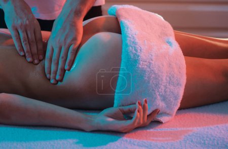 Photo for Professional massage at home. Ideal womans butt anti-cellulite and skin care. Massage and body care. Massage Therapy for Health Purposes. Massage Oils and Scented Body Oil. Relax - Royalty Free Image