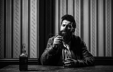 Photo for Man drinking whiskey, brandy, cognac. Degustation and tasting. Man with glass of brandy. Bearded hipster with glass of whiskey. Old traditional whiskey drink - gentlemans beverage - Royalty Free Image