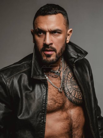 Photo for Fashion style portrait of handsome guy. Fashion brutal guy with sexy naked torso in leather jacket - Royalty Free Image