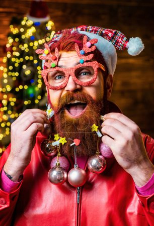 Photo for Christmas or New Year barber shop concept. Merry christmas and happy new year. New year - fun party with funny Santa. Beard with bauble - Royalty Free Image