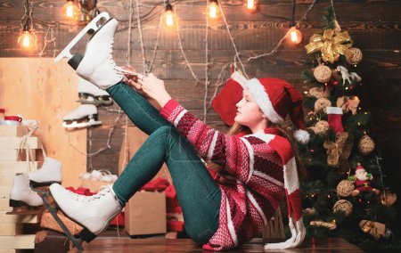 Photo for Cute little teenager celebrating Christmas. Christmas teenager - happiness concept. Children gift. Cute little girl near Christmas tree. White Skates - Royalty Free Image
