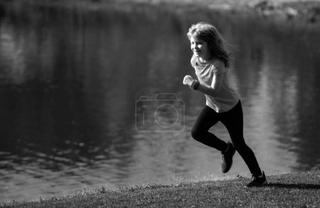 Photo for Child boy jogging in park outdoor. Sporty kid running in nature - Royalty Free Image