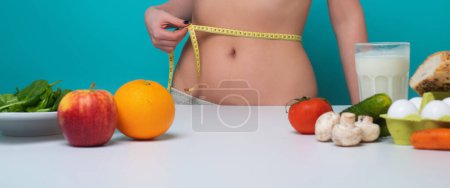 Photo for Healthy Eating. Slim waist. Woman on Diet measure waistline. Calories and diet concept. Vegetarian fresh food. Healthy metabolism. Fit perfect figure, weight loss. Diet Tips. Fitness diets Nutrition - Royalty Free Image