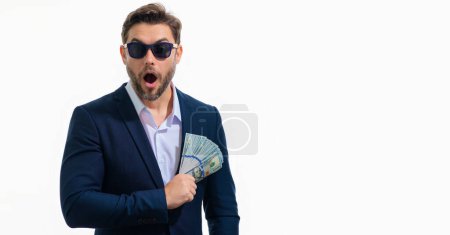 Photo for Handsome man holding money isolated over white banner. Money in dollar banknotes. Pile of cash, finance, investment and money saving. Mockup banner of credit, currency and earnings - Royalty Free Image