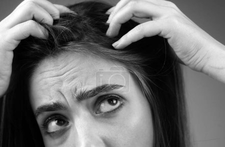 Photo for Stressed woman is very upset because of hair loss. Haircut and straightening hair care. Serious hair loss problem for health care shampoo - Royalty Free Image