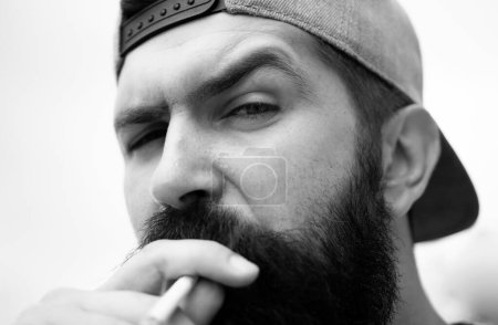 Photo for Closeup portrait of man man smoking cigarette. Handsome guy smoking outside in urban, close up - Royalty Free Image