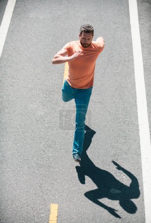 Photo for Active healthy runner jogging outdoor. Man running on the road - Royalty Free Image