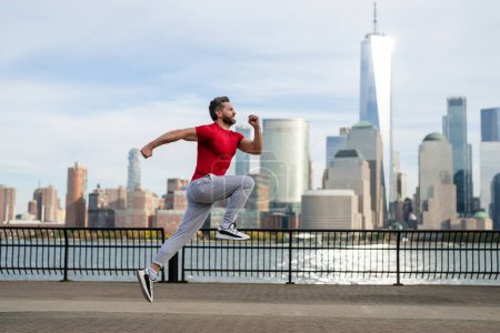 Photo for Sports man doing sport on street. Runners sprinting outdoors. Sportsman training in a urban area, healthy lifestyle sport. Sport man jogging in New York City. Outdoor Sport. Sports wear for runners - Royalty Free Image