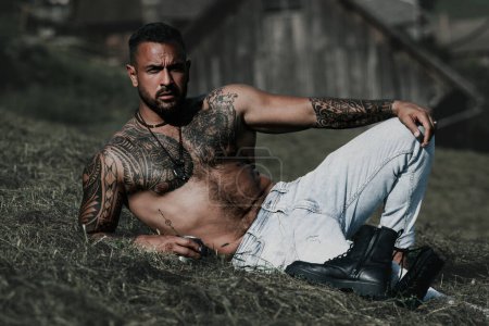 Photo for Hispanic man on nature. Man relax in nature, wellness man. Calm and freedom in environment. Attractive man with naked torso feeing Freedom. Male freedom lifestyle. Strong body, muscles guy. Tattooed - Royalty Free Image