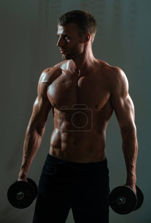 Photo for Sporty torso, man with dumbbells. Portrait of athletic man with dumbbells. Shirtless man man with muscles torso in studio - Royalty Free Image