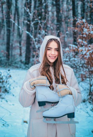 Photo for Winter emotion. Outdoor portrait of young pretty beautiful woman in cold sunny winter weather in park. Portrait of a beautiful woman dressed a coat - Royalty Free Image