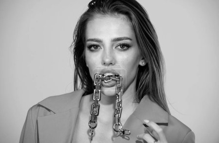 Photo for Sensual woman close up portrait with golden chain in mouth. Female model lick golden chain, sexy face. Vogue Style Portrait - Royalty Free Image