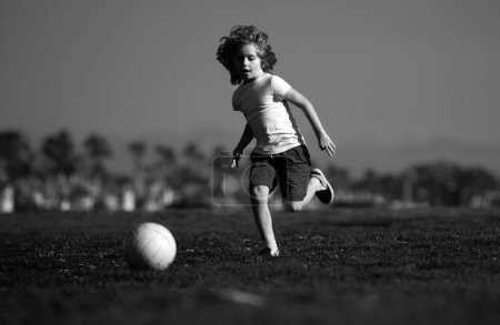 Photo for Soccer kids, child boy play football outdoor. Young boy with soccer ball doing kick. Football soccer players in motion. Cute boy in sport action - Royalty Free Image