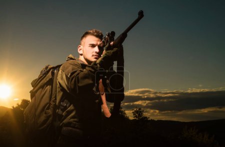 Photo for Track down. Rifle Hunter Silhouetted in Beautiful Sunset. Most realistic hunting game ever created. Hunting Gear - Hunting Supplies and Equipment - Royalty Free Image