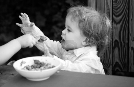 Photo for Baby food, babies eating. Healthy kids breakfast. Good appetite - Royalty Free Image