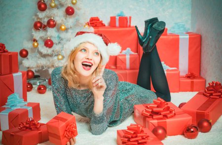 Photo for Sexy woman. New year girl. Sensual young woman. Glamour celebration. Christmas fashion. Smiling beautiful young girl holding red present box - Royalty Free Image