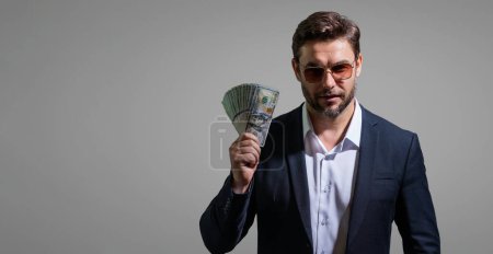 Photo for Successful business man counting money. Handsome middle age man holding bunch of 100 dollar banknotes. Guy holding money cash. Profit and financial success. Rich man with dollar cash - Royalty Free Image