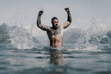 Photo for Naked muscular Hispanic man splashing water in lake. Attractive male sexy model in water. Handsome boy rest in Alps lake water. Sexy man naked torso in water. Man freedom lifestyle. Strong muscles guy - Royalty Free Image
