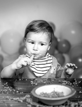 Photo for Baby food, babies eating. Funny kid boy with plate and spoon - Royalty Free Image