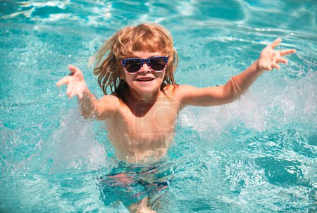 Photo for Cute child boy swim in swimming pool, summer water background with copy space. Cute boy in the water playing with water. Boy splashing in swimming pool having fun leisure activity open arms - Royalty Free Image