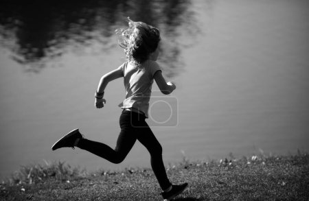 Photo for Child boy jogging in park outdoor. Kids sport, happy active kids jogging outdoors, running in spring park. Morning jogging - Royalty Free Image