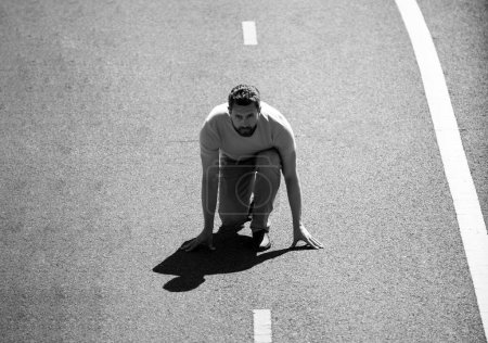 Photo for Full length of healthy man running and sprinting outdoors on road. Male runner on start - Royalty Free Image
