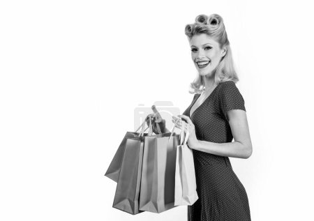 Téléchargez les photos : Pinup woman shopping. Big sales. Pretty lady shopaholic. Isolated - en image libre de droit
