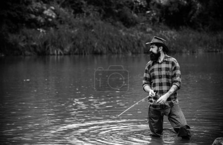 Photo for Fisherman man on river or lake with fishing rod - Royalty Free Image